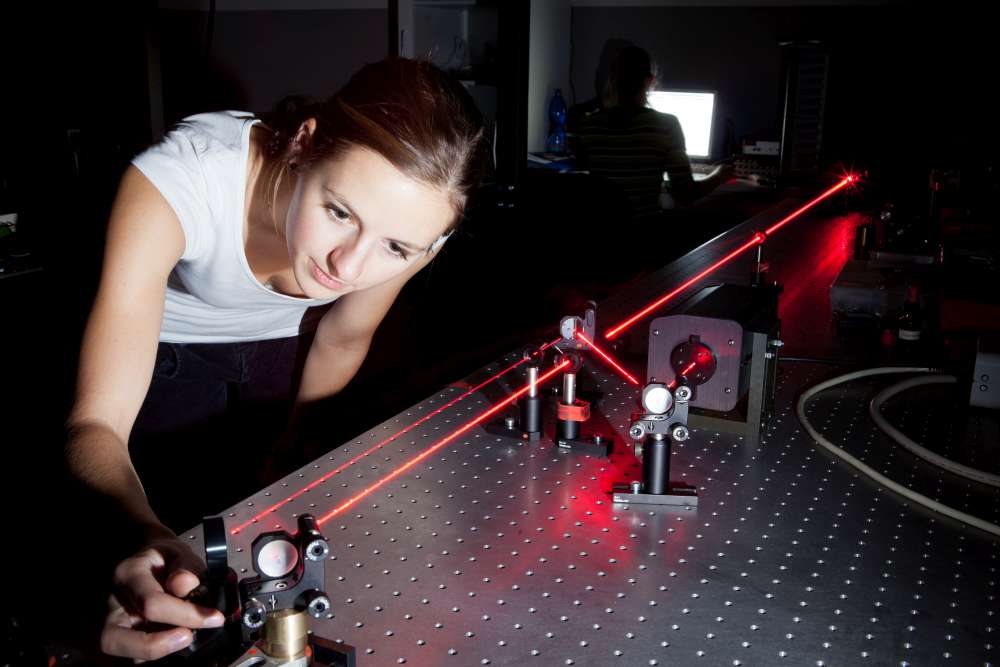 female scientist doing research in a quantum optics lab